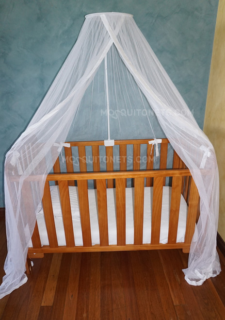 wooden cot with mosquito net