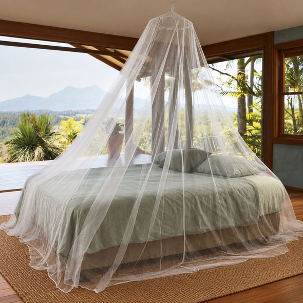 Round travel mosquito net hanging from one hook over a king bed