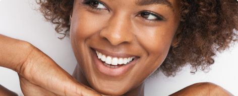 African American model smiling with radiant skin.