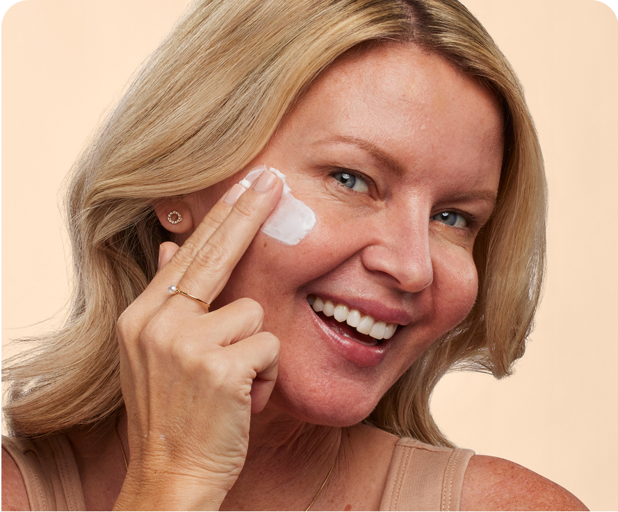 Woman using Olay Regenerist Micro-Sculpting Cream to reduce signs of aging at home