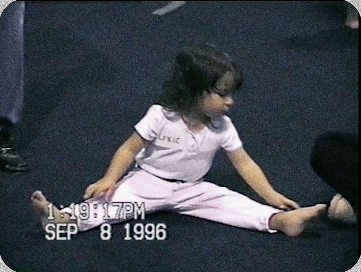 Young Aly dusts her hands with chalk imagining herself doing all the moves.