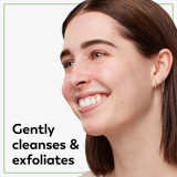 Model posing and smiling. Cleans, hydrates, and gently exfoliates.