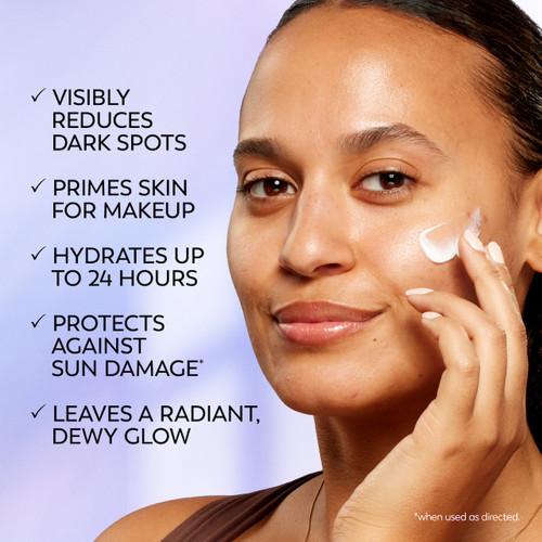 Model posing applying Olay Super Cream Mini with Sunscreen SPF 30, Ultra Lightweight SPF Face Moisturizer to face. Visibly reduces dark spots. Primes skin for makeup. hydrates up to 24 hours. Protects against sun damage. leaves a radiant dewy glow.