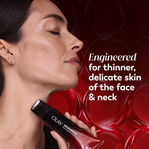 Model posing applying Regenerist Face & Neck Lifting Treatment rolle to neck. Engineered for thinner, delicate skin of the face and neck.