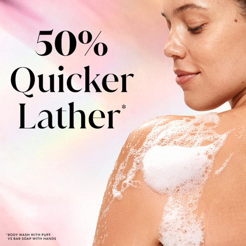 Model posing back facing while lathering Fresh Radiance Body Wash on shoulder. 50% quicker lather.*. *body wash with puff vs bar soap with hands