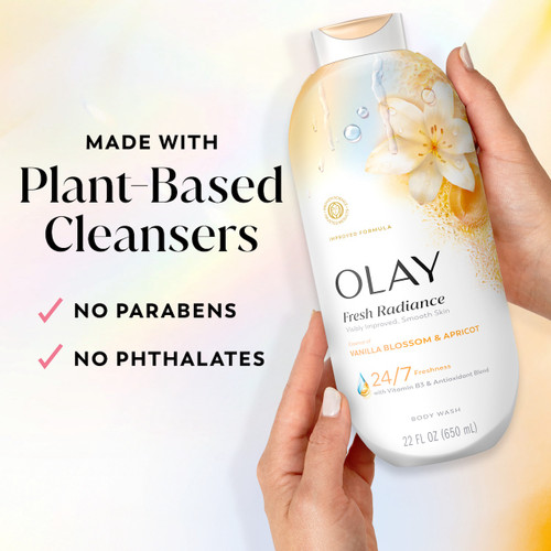 Model holding Fresh Radiance Body Wash bottle. Made with plant based cleansers. No parabens, no phthalates