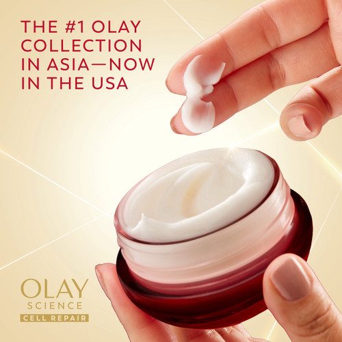 Model holding OLAY Ultra Rich Cream jar while dipping fingers in cream. The #1 Olay collection in Asia, now in the USA. Olay science cell repair