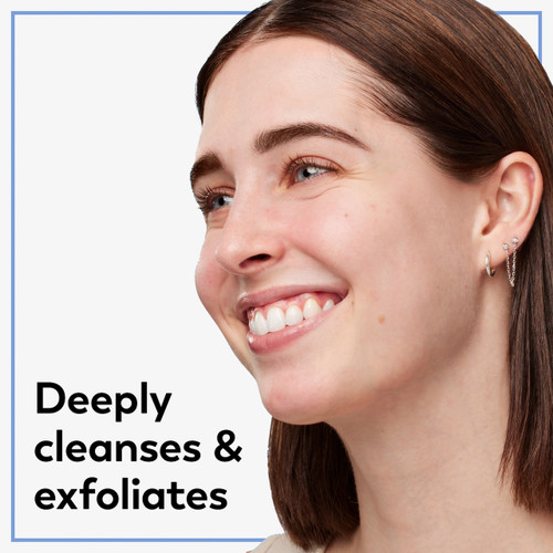 Model posing and smiling. Deeply cleanses and exfoliates.