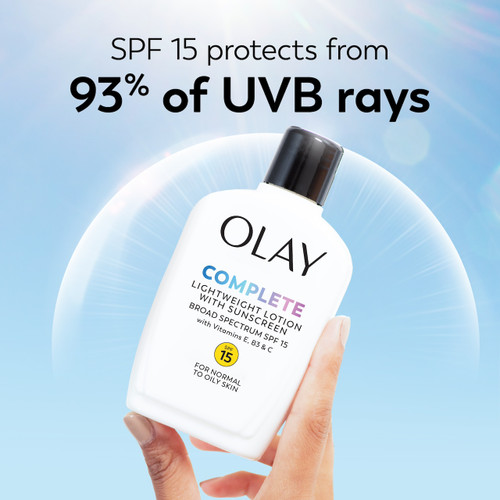 Olay Complete Lotion Moisturizer with SPF 15 Normal bottle in hand. SPF 15 protects from 93% of UVB rays.