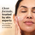 Model posing applying Total Effects Face Moisturizer Original to face. Clean formula, trusted by skin experts. No parabens, phthalates, or mineral oil
