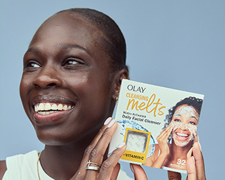 Athing Mu U.S. Olympian holding a box of Olay Cleansing Melts + Vitamin C beside her face