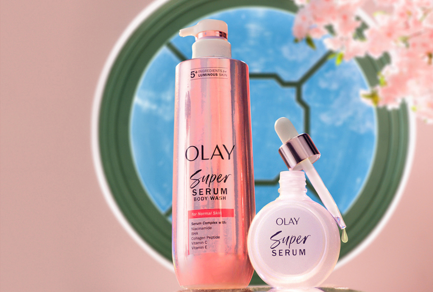 Olay Super Serum and Super Serum Body Wash on a pedestal in front of a circle window and pink flow branch from the World of Oz