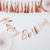 A rose gold foil banner displaying the words "Happy Birthday," 2 decoration fans on a white background.