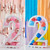 Two visuals displaying cheerful balloons on a Balloon Mosaic Stand number 2, white a colourful background