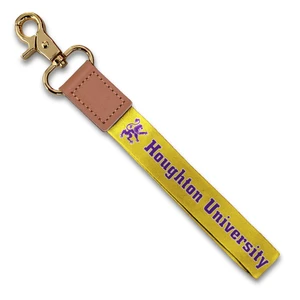 gold wristlet with purple and white rampant lion and Houghton University. Secured by leather to a metal clip