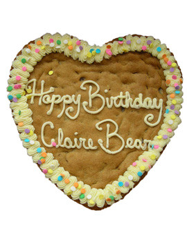 giant heart cookie with frosting around edge and says "Happy Birthday Claire Bear"
