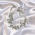 headband features a beautiful combination of soft pearls and sparkling crystals arranged in a floral design.