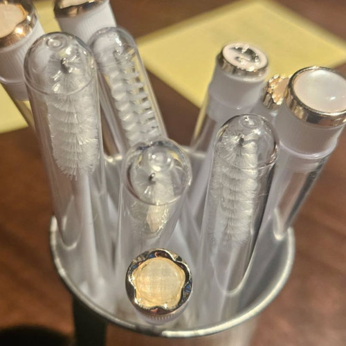 Tube with white mascara wands