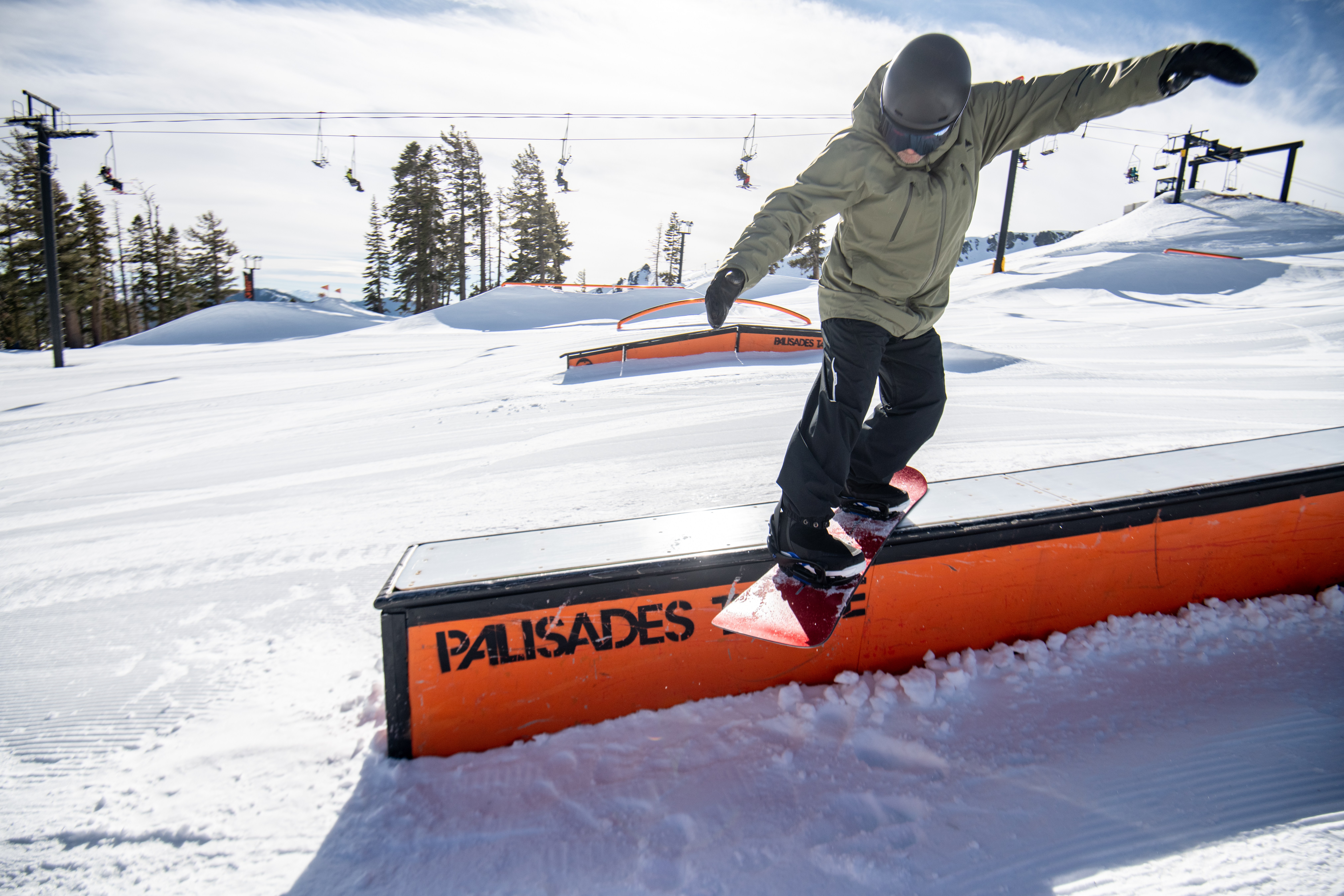 snowboarder grinding on terrain box
