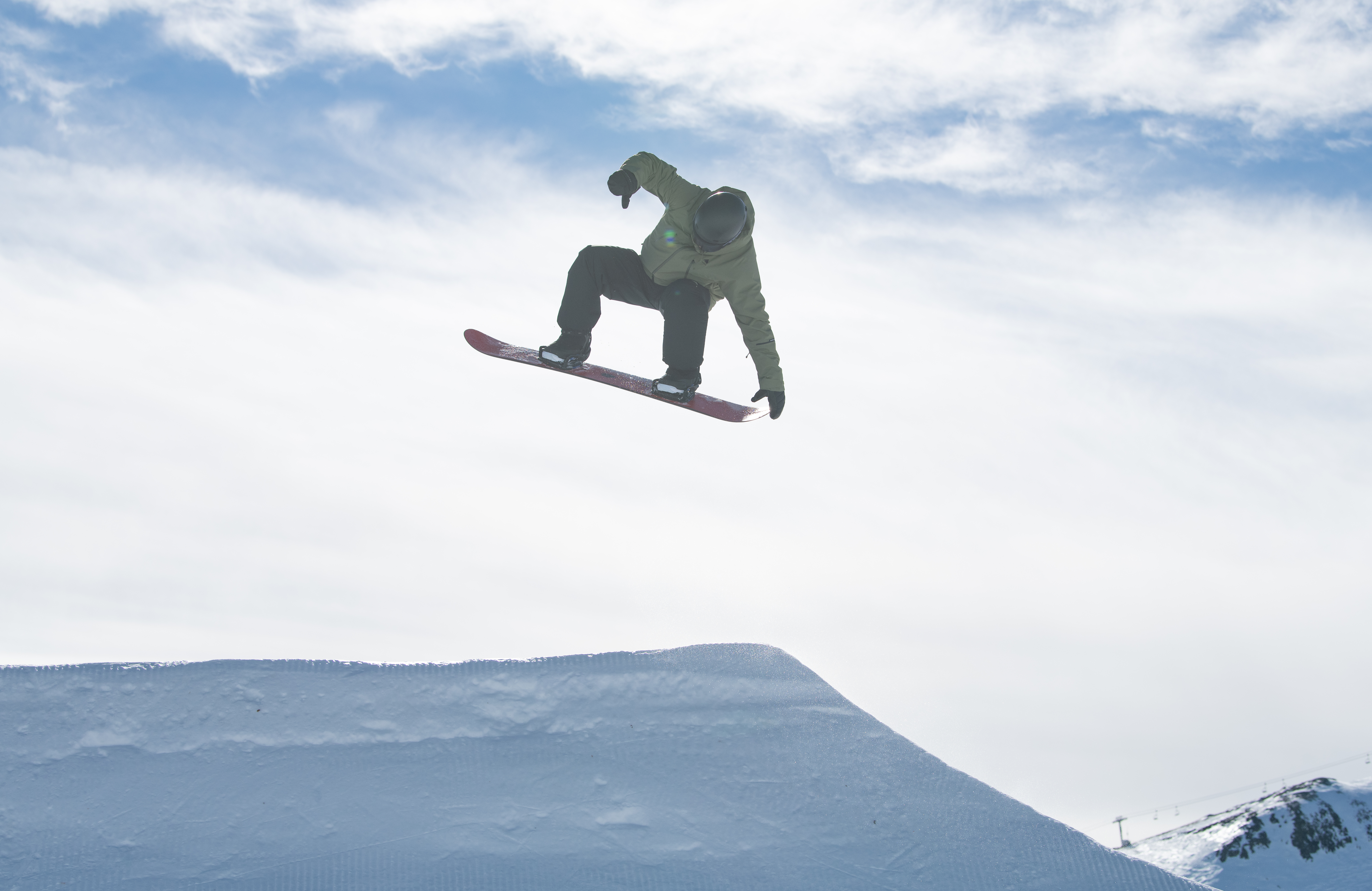 main on snowboard jumping in air