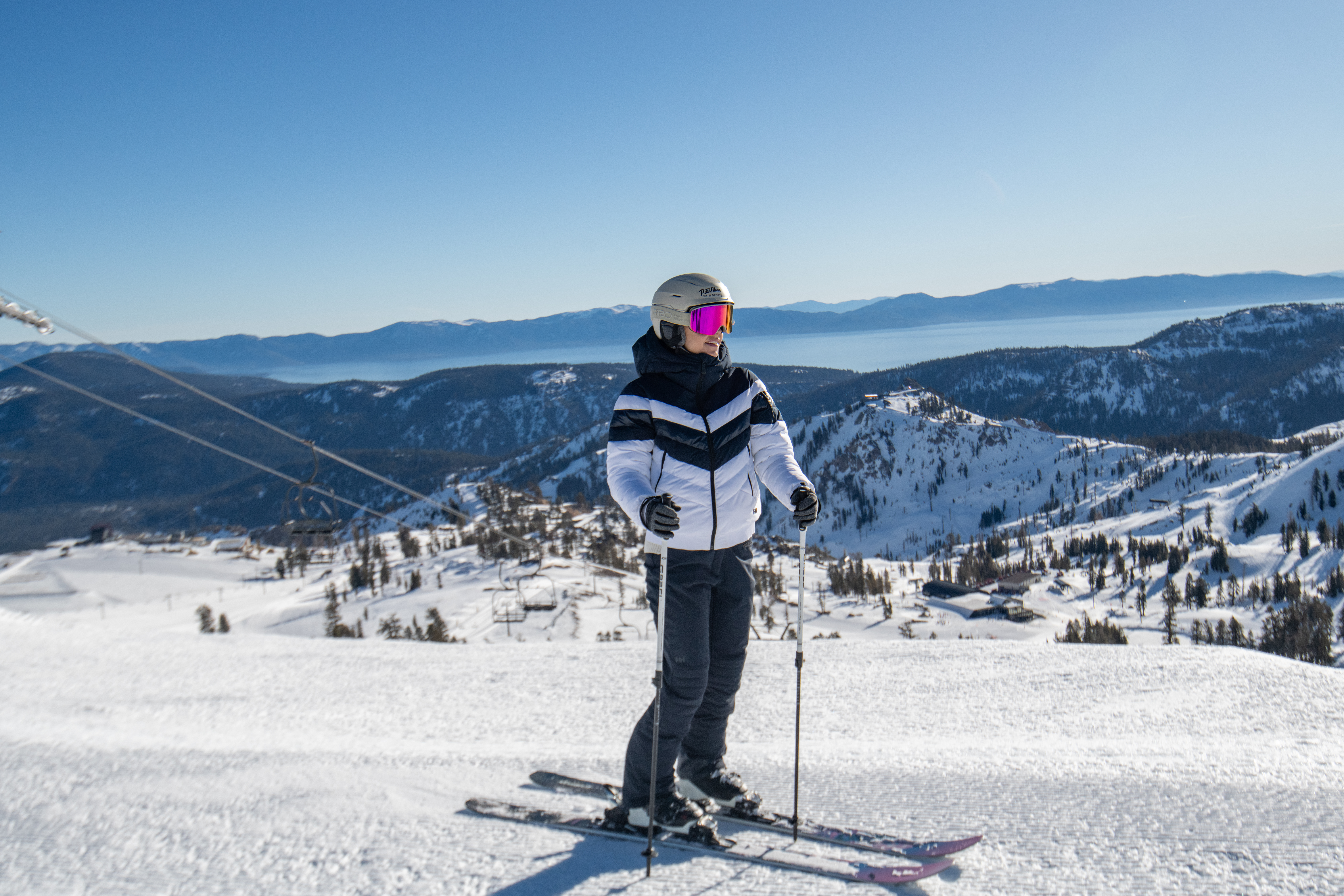 woman standing on mountain on skis holding ski poles