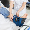 Nurse placing an Invacare Maxxcare Heel Boot onto a patients' foot