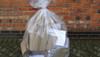 Full up Clear Refuse Sack against a brick wall outside.