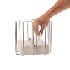 A hand holding Olympia Wire Napkin Holder with napkins inside.