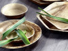 Full shot of Full shot of Compostable Palm Leaf Wooden 18cm Round Plate with content.