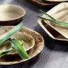 Full shot of Compostable Palm Leaf Wooden 24cm Round Plate with content.