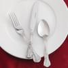 Olympia Kings Solid Handle Table Knife together with spoon and fork placed on a plate.