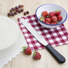 Hygiplas Straight Blade Palette Knife Black 25.5cm placed on table napkin cloth with strawberries and grapes.