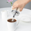 Olympia Sugar Pourer With 19mm Single Spout poured into a cup of coffee.