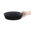 Vogue Deep Non-Stick Quiche Tin With Removable Base 250mm in hand.