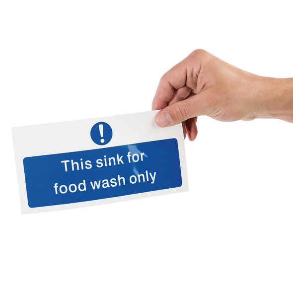 Hand holding Vogue Food Wash Only Sign.