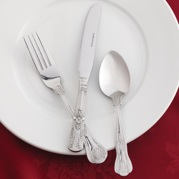 Olympia Kings Solid Handle Table Knife together with spoon and fork placed on a plate.