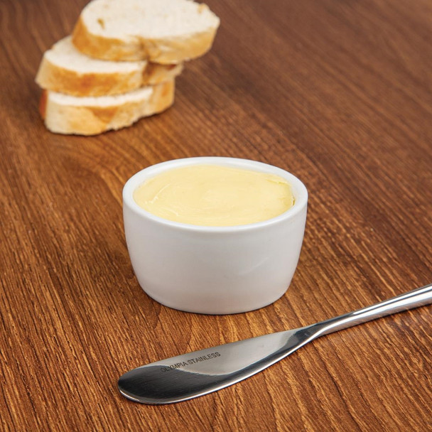 Whiteware Butter Dish 62mm with content together with bread knife and toasted bread in the table.