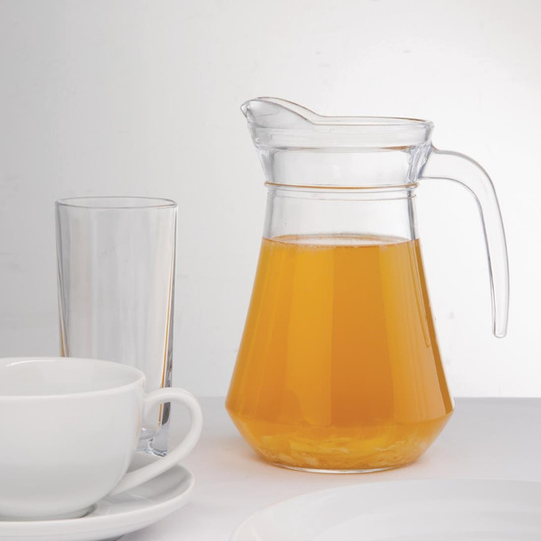 Olympia Glass Jugs 1Ltr with content, glass of water, cups and saucer, and plates on table.