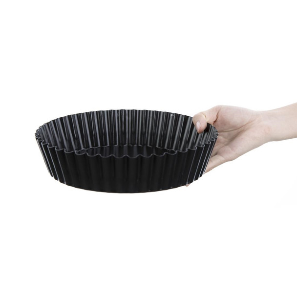 Vogue Deep Non-Stick Quiche Tin With Removable Base 250mm in hand.