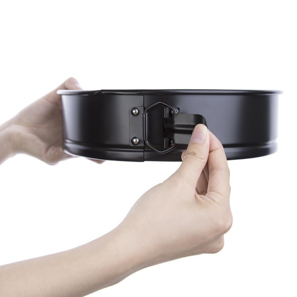 Hand holding Vogue Non-Stick Spring Form Cake Tin 260mm showing its lock.