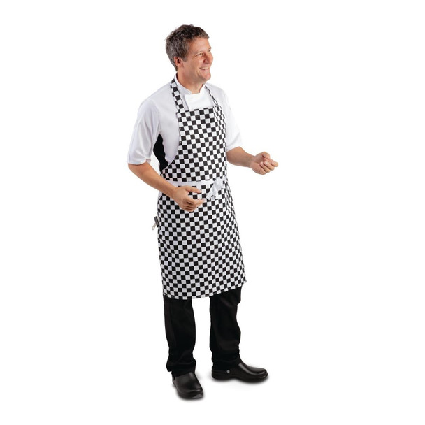 Side shot of man wearing Chef wearing Whites Bib Apron Black and White Check..