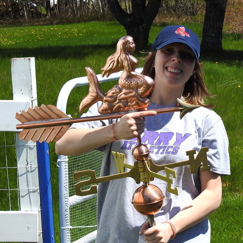 Jamey holding a mermaid weathervane