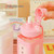 JHTPSLR Large Kawaii Water Bottle with Straw and 3D Stickers Cute Aesthetic Bottle Kawaii Milk Bottle Tea Cup Juice Shaker Portable Silicone (700ml/24oz, Pink)