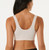 Beige seamless stretch bra with front closure, breathable anti-bacterial fabric, non-adjustable straps, and a comfortable A–D cup fit. Available in sizes S to XXXL.