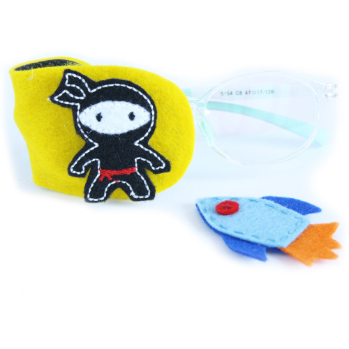 Yellow felt eye patch with ninja and rocket decorations