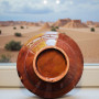 Moroccan plate with intricate leaf-carved border and red sunburst Glow and Clay