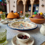 Glow and Clay artisan Moroccan plate featuring hand-painted terracotta and navy motifs