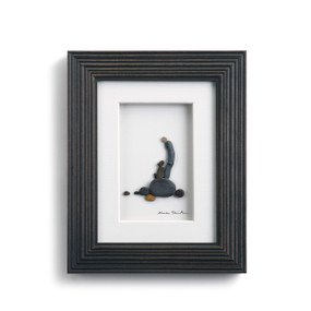 Dark wooden outline frame - image of pebble figurine next to dog figurine on rocks