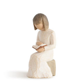 Front view of female figure in cream dress, seated on rock, reading a book