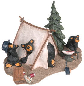 Black bear figurine in tent under gravel with tree